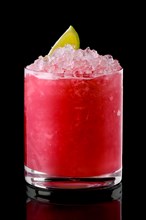 Glass of cold cranberry cocktail with crushed ice isolated on black background