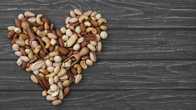 Heart shape form made from nuts copy space