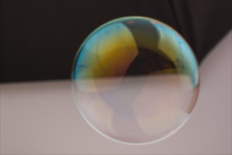 Blown single soap bubble in the air