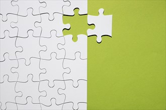 White puzzle piece separate with white puzzle grid green backdrop. Resolution and high quality beautiful photo