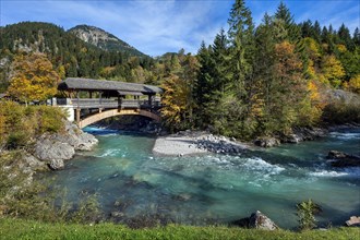 Wooden bridge over the Ostrach in the autumnal Ostrachtal