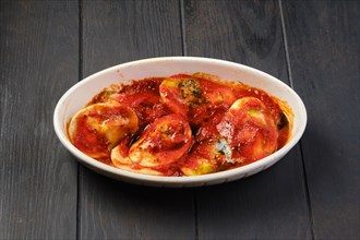 Lamb dumplings with spicy tomato sauce baked in oven