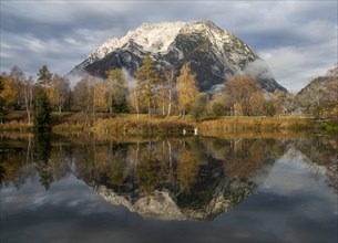 Mount Grimming reflected in the lake in autumn