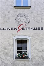 Facade with window and logo of Loewen und Strauss Wirtschaft