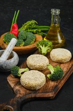 Semifinished homemade chicken cutlet with broccoli on a wooden serving board