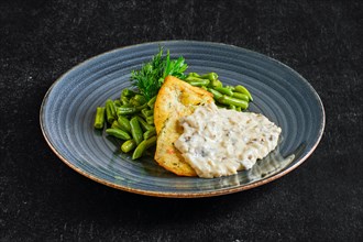 Fried chicken fillet with green beans and mushroom sauce