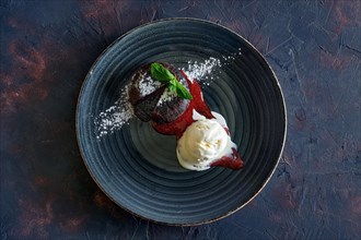 Top view of chocolate fondant with ice cream and strawberry jam