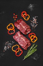Overhead view of raw fresh lamb neck meat with slices of bell pepper
