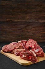 Assortment of raw fresh lamb meat on wooden tray
