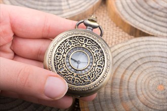 Mechanical pocket watch on pieces of wood