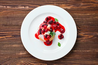 Overhead view of american pancakes with strawberry and black currant jam