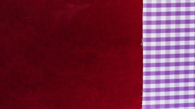 Elevated view chequered pattern textile plain burgundy fabric