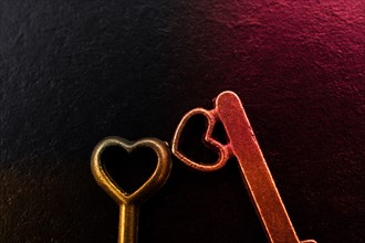 Heart shaped retro metal keys on dark background