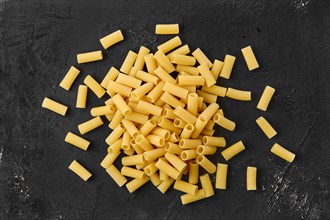 Top view of rigatoni pasta on black table