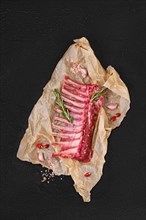 Overhead view of raw fresh rack of lamb in wrapping paper