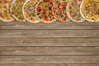 Horizontal collage of different baked pizzas on dark wooden table. Top view