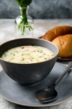 Bowl with cheese and onion soup and fresh bun