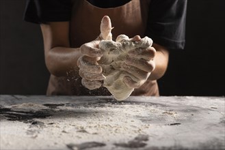Chef kneading dough hands