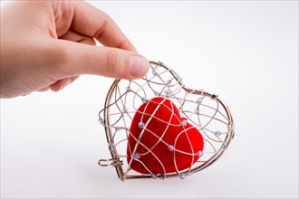 Red heart in a heart shaped cage