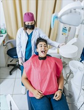 Dentist performing intraoral radiography assessment on a patient