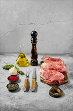 Raw lamb leg cut as a steak. Slices of shank on cutting board