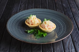 Appetizer for reception. Tartlet with cheese and crab meat