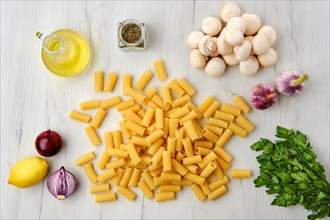 Overhead view of rigatoni pasta on wooden table