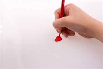 Pencil pointing a red heart