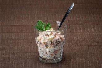 Russian traditional salad olivier with pea in glass