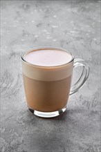 Transparent cup of cappuccino with foam