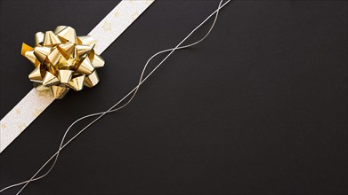 Decorative ribbon bow silver string black background