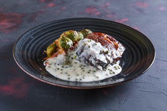Fried beefsteak with Brussels sprouts and creamy pea sauce