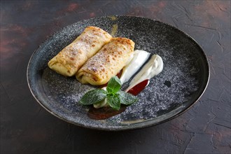 Thin pancakes with curd and sour cream