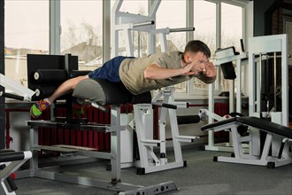 Sportsman doing crunches in the gym. Fitness workout