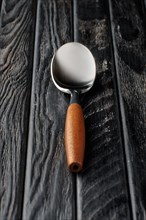 Soft focus photo of stylish spoon with wooden handle