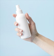 Person holding disinfection bottle