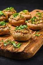 Closeup view of baked mushrooms stuffed with cheese