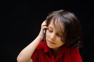 Little boy hold smartphone as modern mobile communication gadget