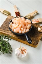 Frozen peeled shrimps in frying pan