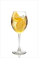 Apple and orange cocktail with a sparkling wine with ice in wine glass isolated on white