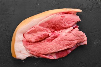 Raw fresh pork shoulder joint meat on black background