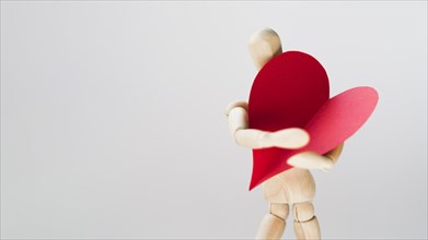 Toy manequin holding heart with copy space. Resolution and high quality beautiful photo