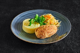 Traditional Kiev cutlet with mashed potato and pickled cabbage