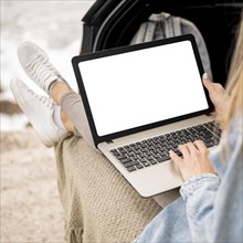 Young woman browsing laptop on road trip. Resolution and high quality beautiful photo
