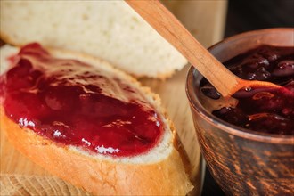 Macro photo with shallow depth of field of bread with cranberry jam