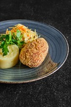 Traditional Kiev cutlet with mashed potato and pickled cabbage