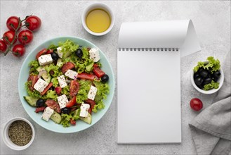 Top view salad with feta cheese tomatoes and olives with blank notepad. Resolution and high quality beautiful photo