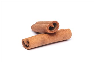 Two cinnamon sticks on white background with shadow