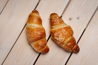 A pair of fresh croissant on the table