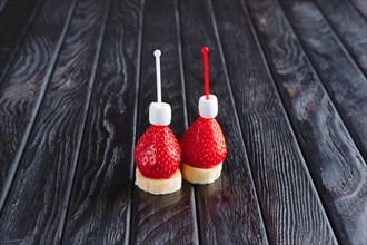 Appetizer for reception. Fresh banana with strawberry and small marshmallows on skewer